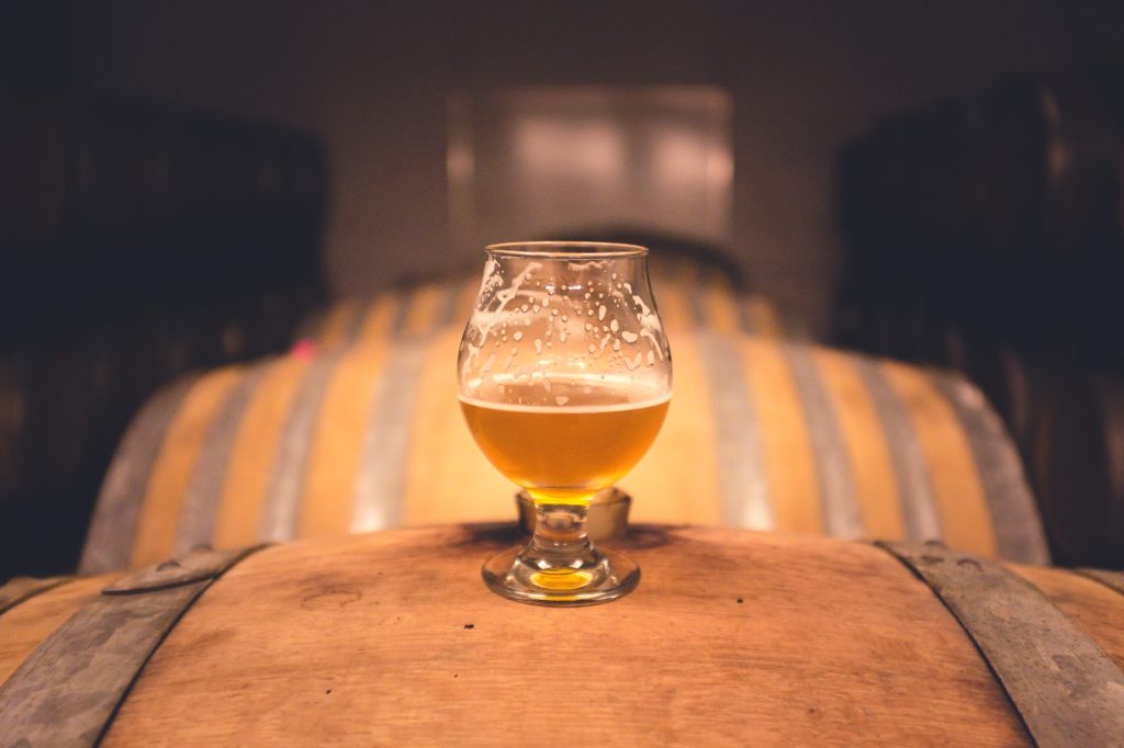 Craft brewers place beer on a Wooden Keg